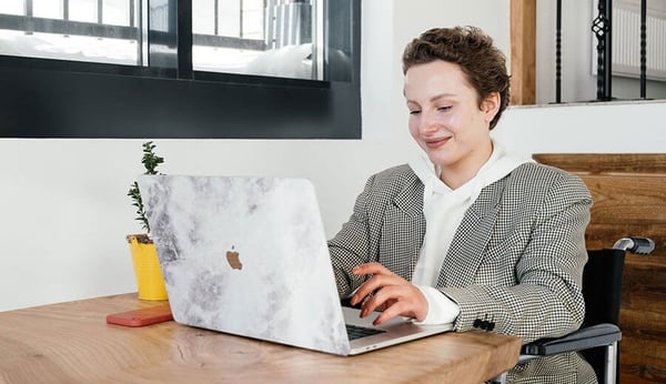 Person smiling at laptop