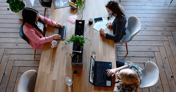 three employees working in an office